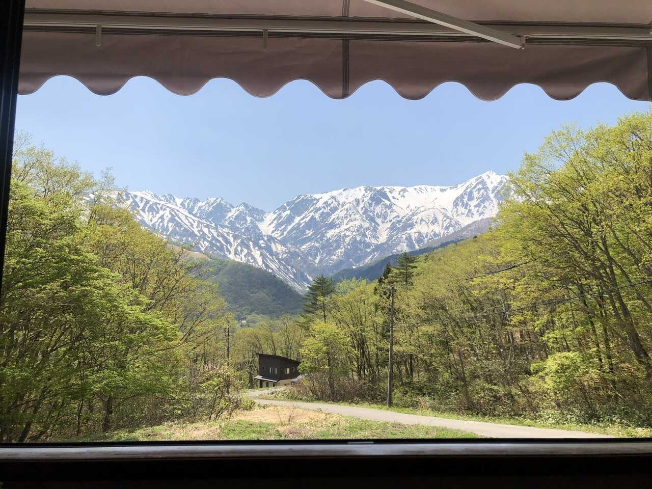 春、カフェからの新緑と雪山